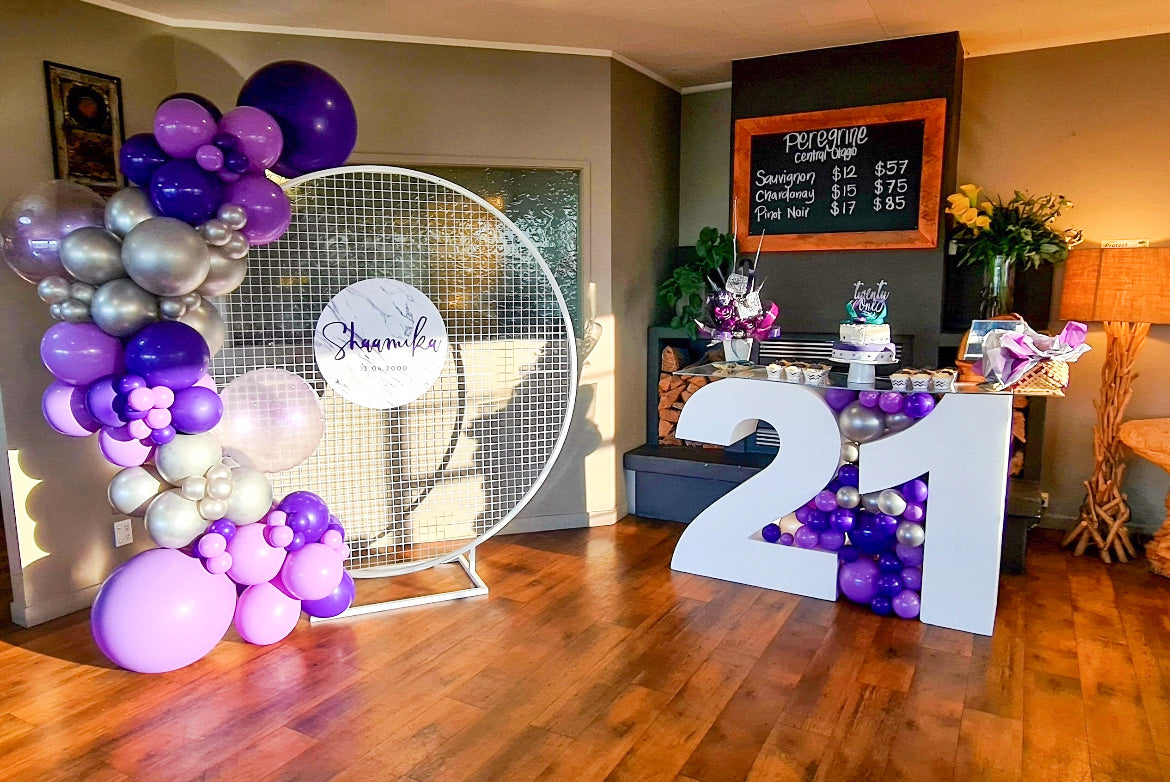 Twenty one balloon garland display featuring mesh hoop round ring hoop balloon garland decorations custom signage 21 display table for hire event decoration service for 21st birthday