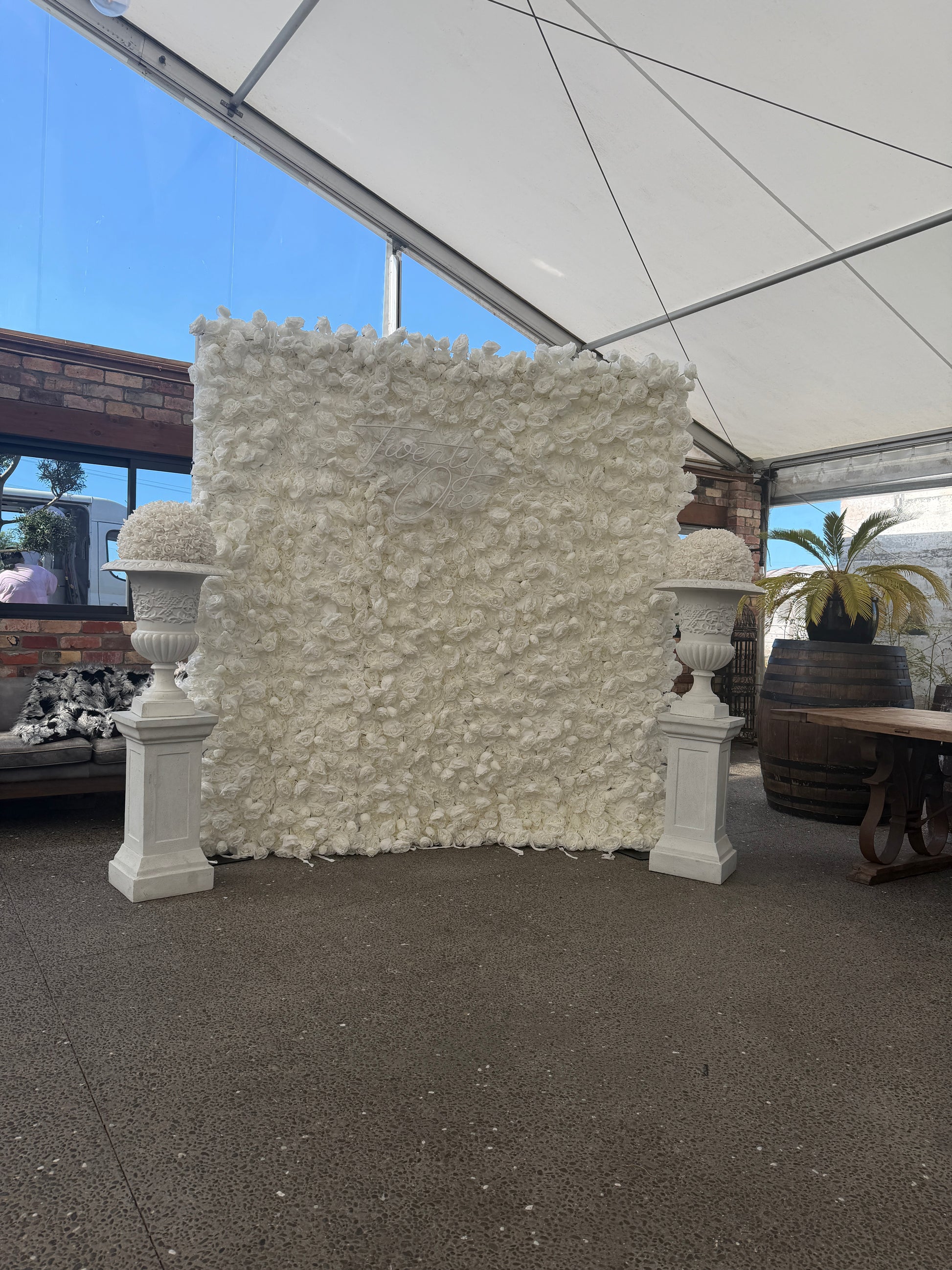 White flower wall backdrop display for twenty first birthday event with neon rental 