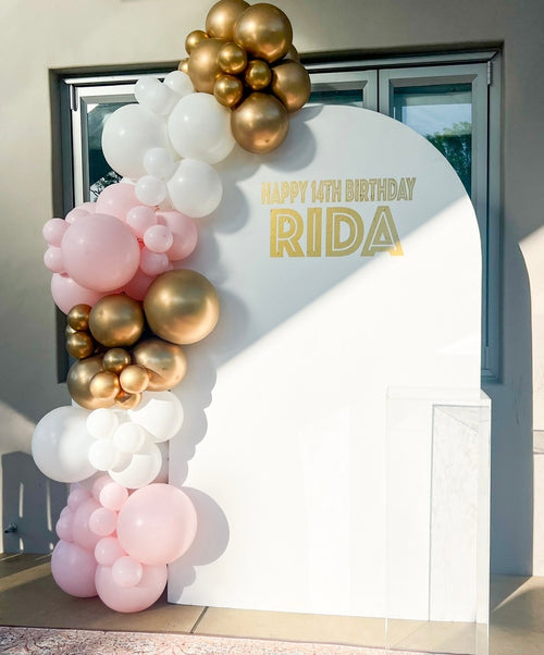 Arch board with balloon garland decoration services backdrop for hire for birthdays with custom signage and cake stand 